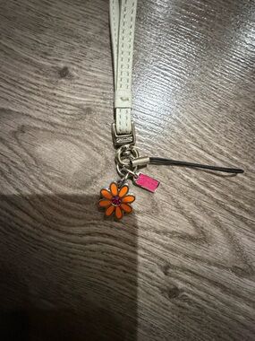 White Wristlet Strap with Orange Daisy Charm
